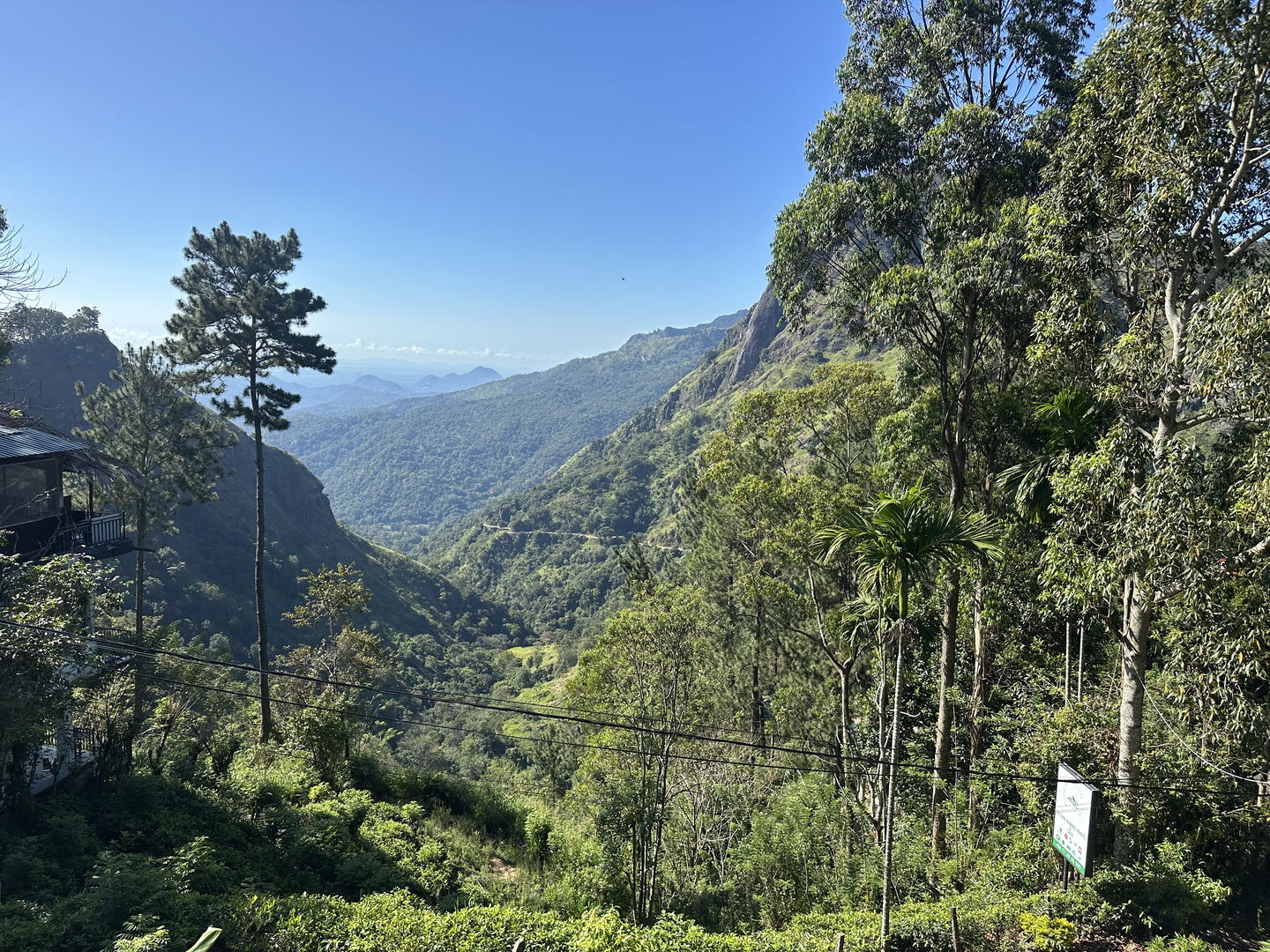 The gap below Ella: a wooded valley running between two ridges, with hills going back into haze.